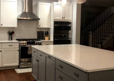 A Large, Clean, And Well-Lit Kitchen With White Cabinets And A White Countertop (1)