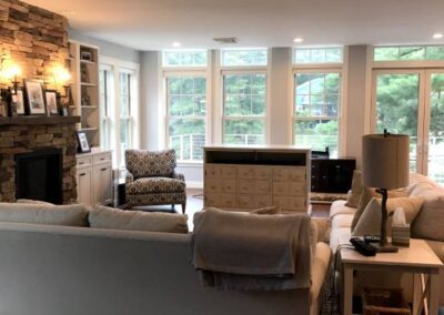 A Spacious And Well-Lit Living Room With A Large Window That Allows Natural Light To Fill The Space.